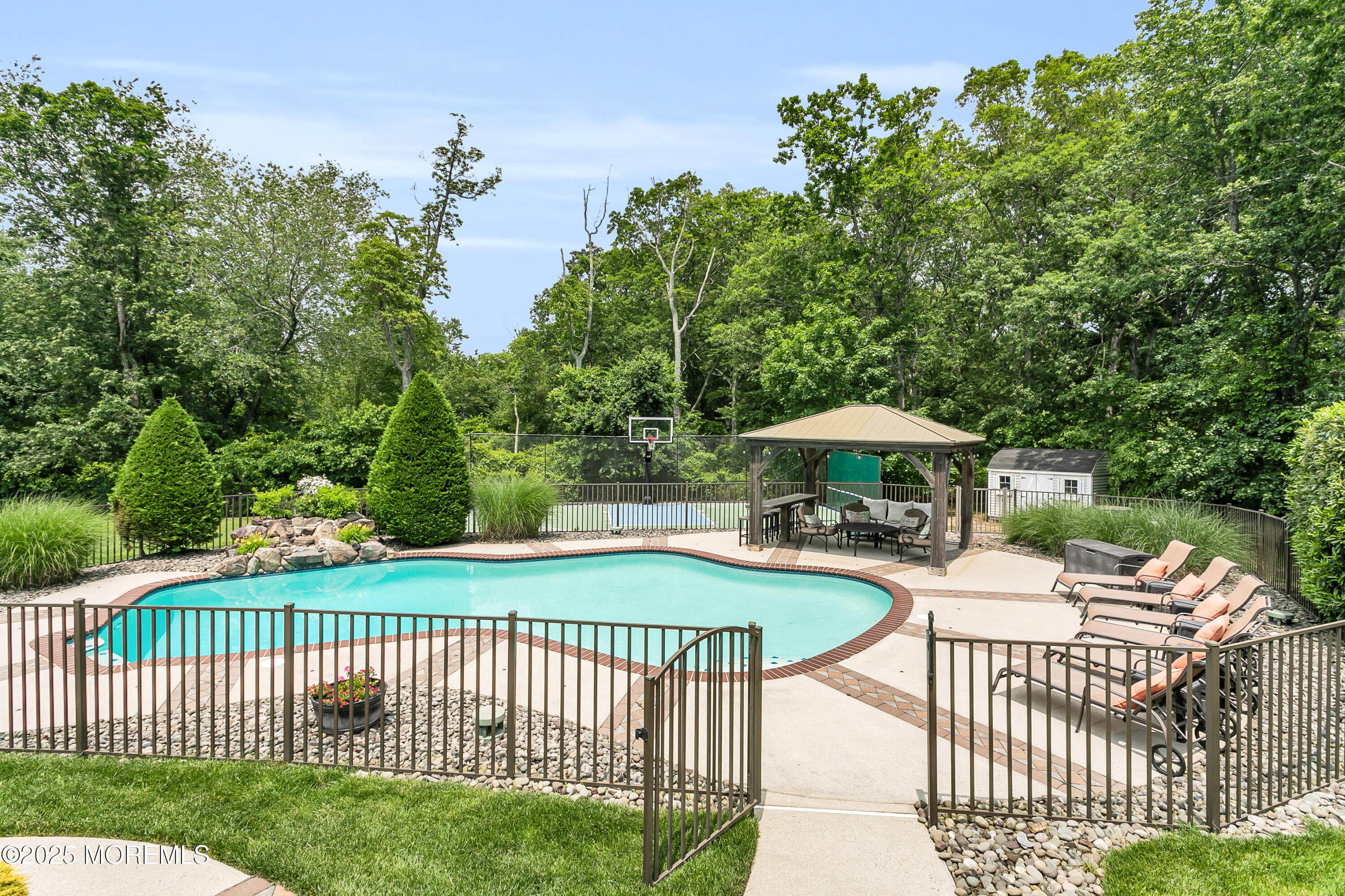 529 Woodview Road Toms River, NJ 08755 - Photo 59 of 85 a view of a patio with a table and chairs under an umbrella