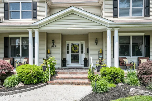 a view of a patio with chair and potted plants