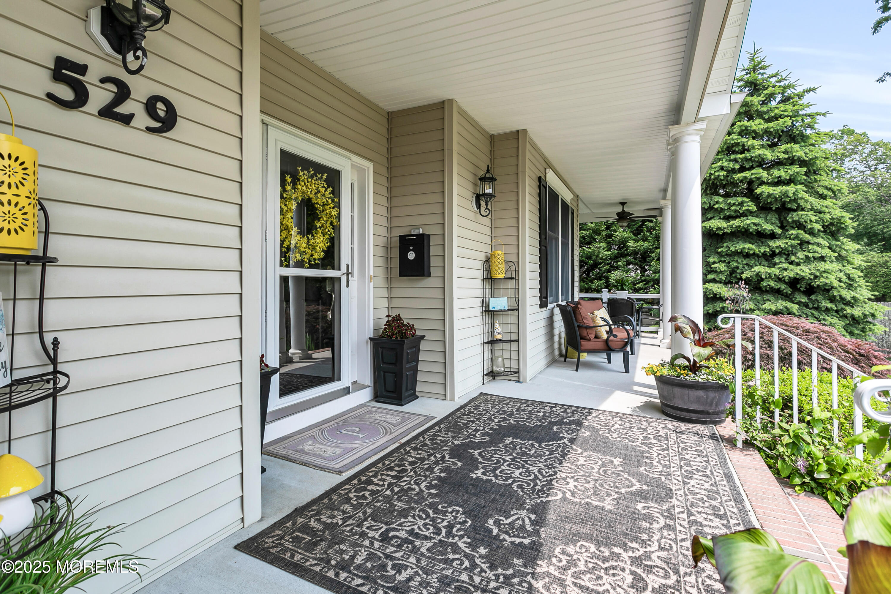 529 Woodview Road Toms River, NJ 08755 - Photo 9 of 85 a view of a porch with chairs and potted plants