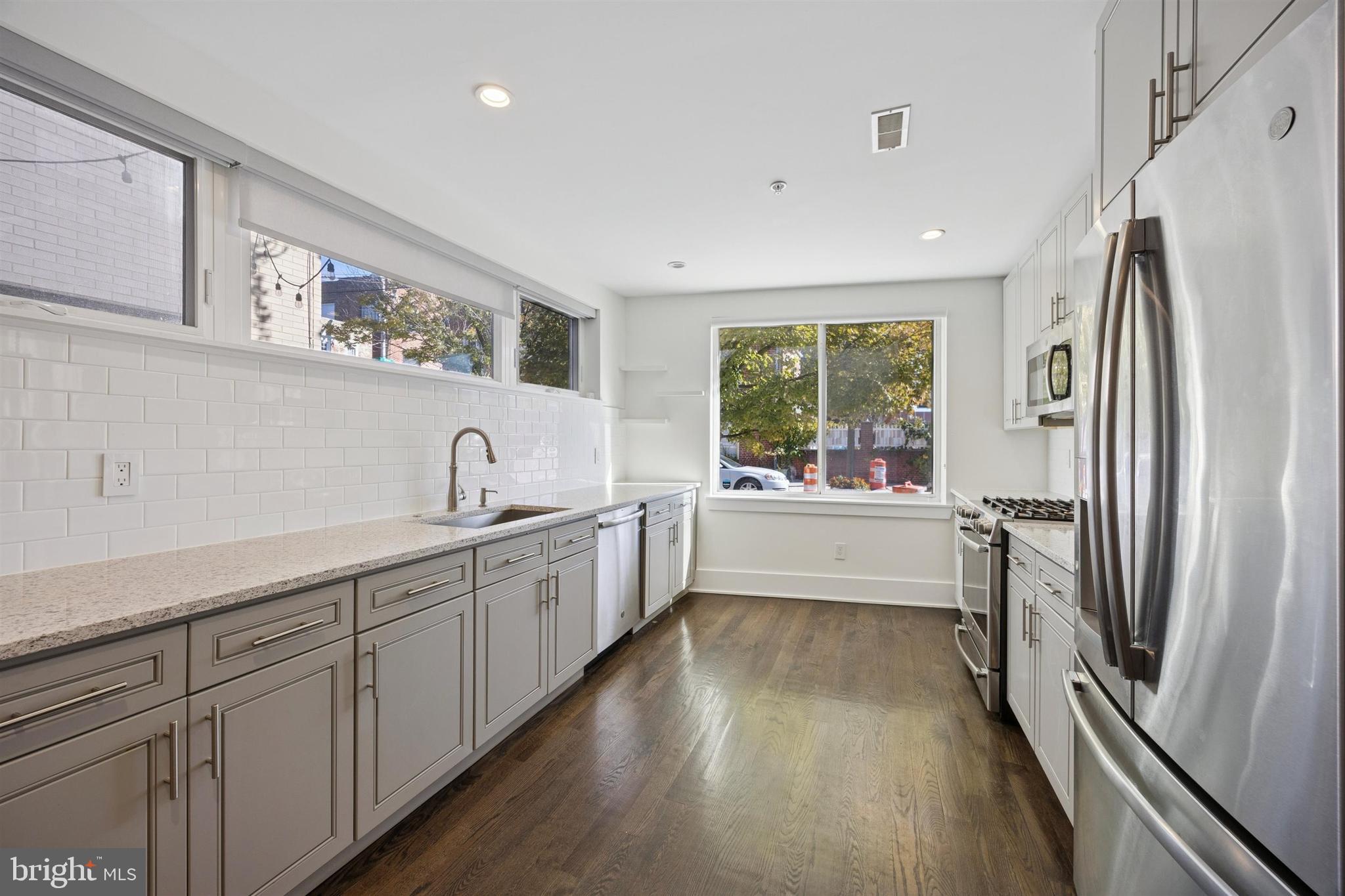 1022 South 2nd Street, Unit 7 Philadelphia, PA 19147 - Photo 13 of 28 a large white kitchen with a large window
