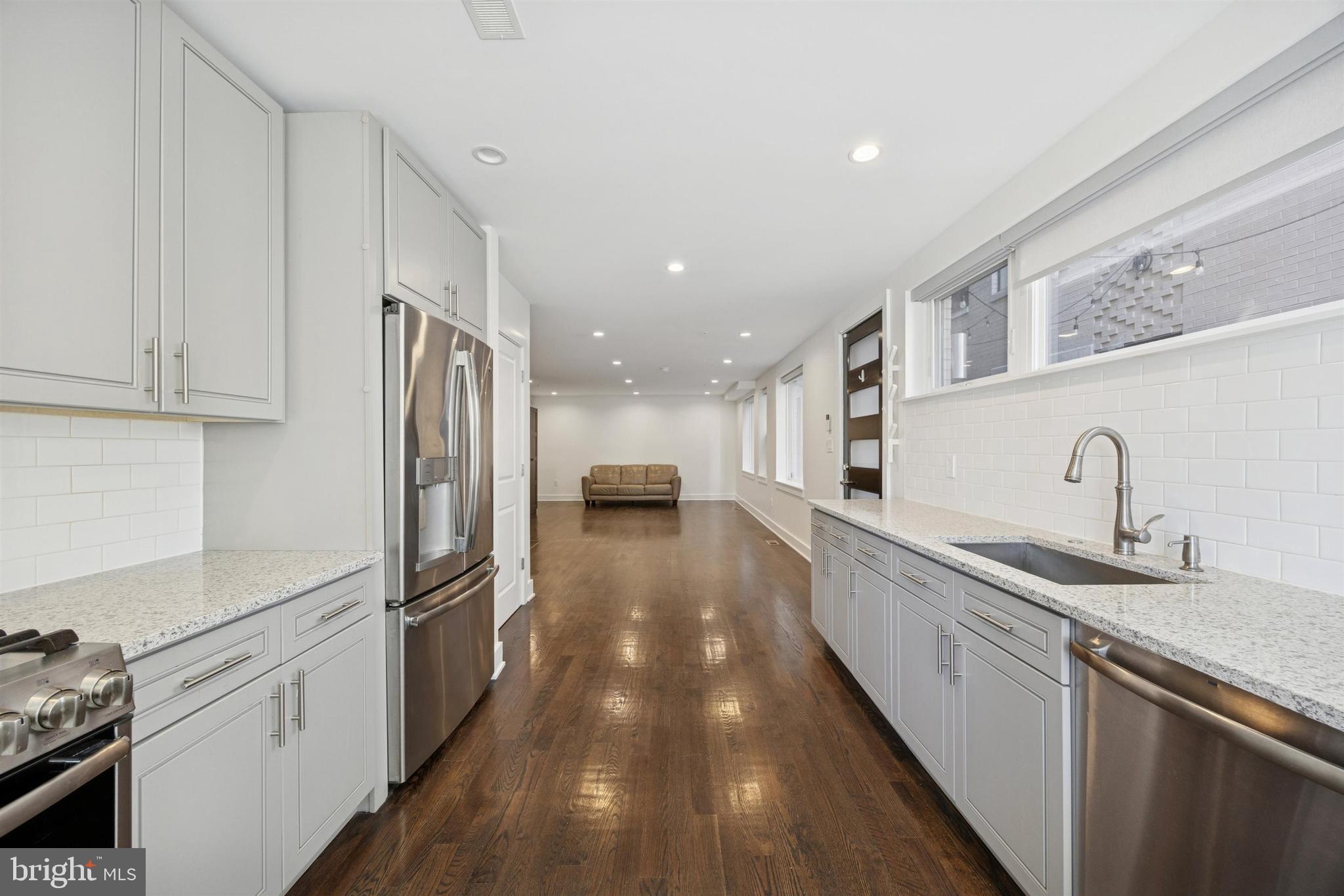 1022 South 2nd Street, Unit 7 Philadelphia, PA 19147 - Photo 10 of 28 a kitchen with stainless steel appliances a refrigerator sink and cabinets
