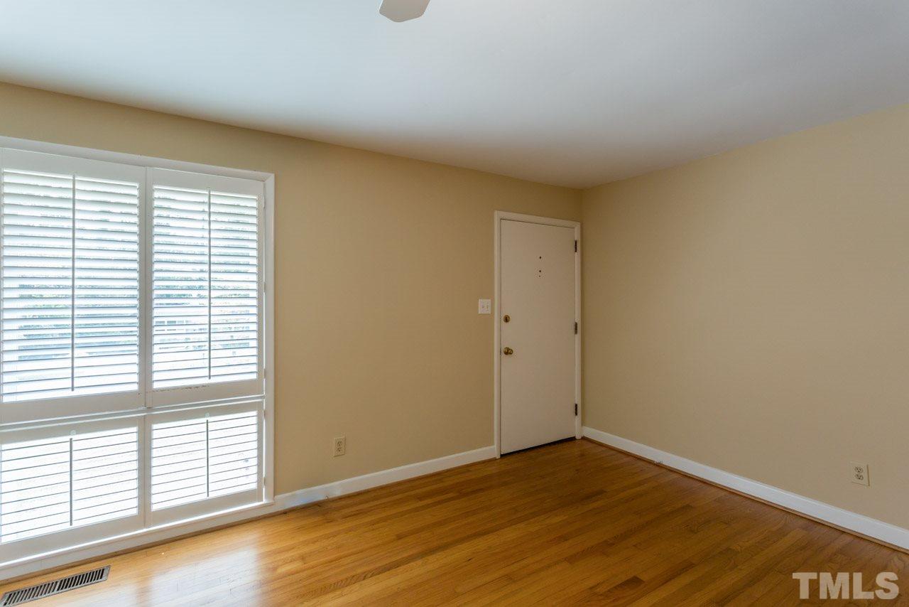 3408 Cherry Lane Raleigh, NC 27607 - Photo 2 of 25 wooden floor in an empty room with a window