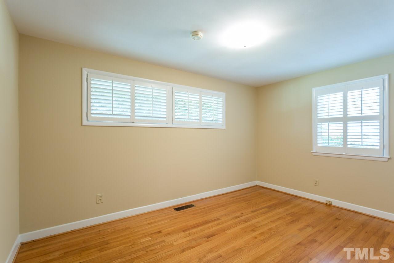 3408 Cherry Lane Raleigh, NC 27607 - Photo 11 of 25 an empty room with wooden floor and windows