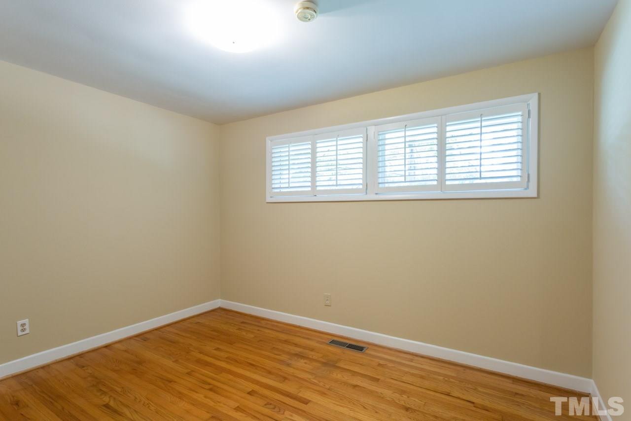 3408 Cherry Lane Raleigh, NC 27607 - Photo 12 of 25 an empty room with wooden floor and windows