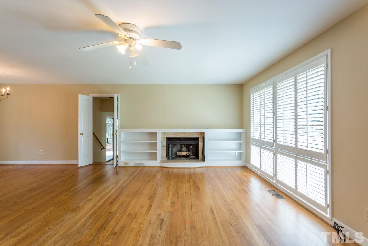 3408 Cherry Lane Raleigh, NC 27607 - Photo 4 of 25 wooden floor fireplace and windows in an empty room