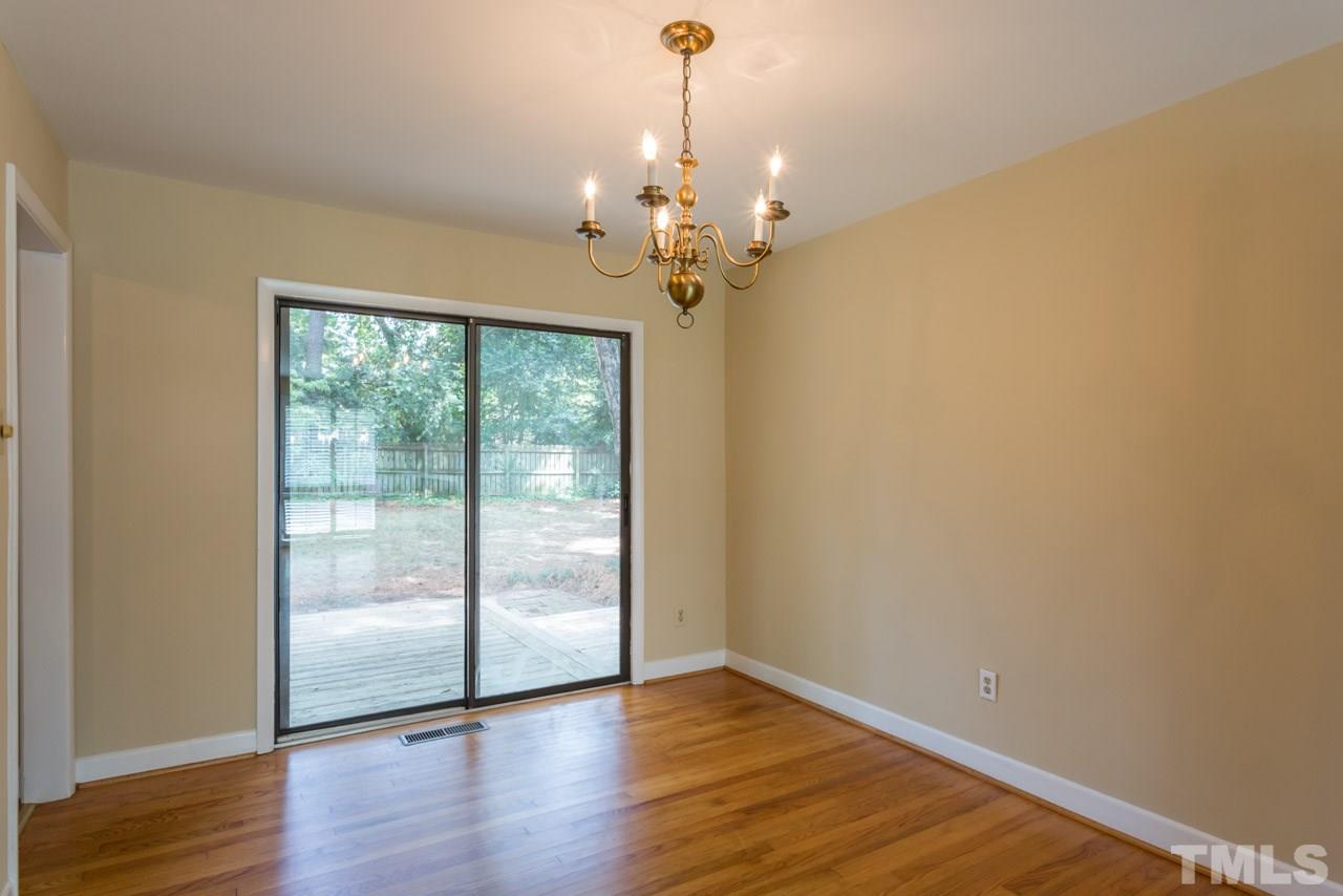 3408 Cherry Lane Raleigh, NC 27607 - Photo 7 of 25 a view of an empty room with wooden floor and a window