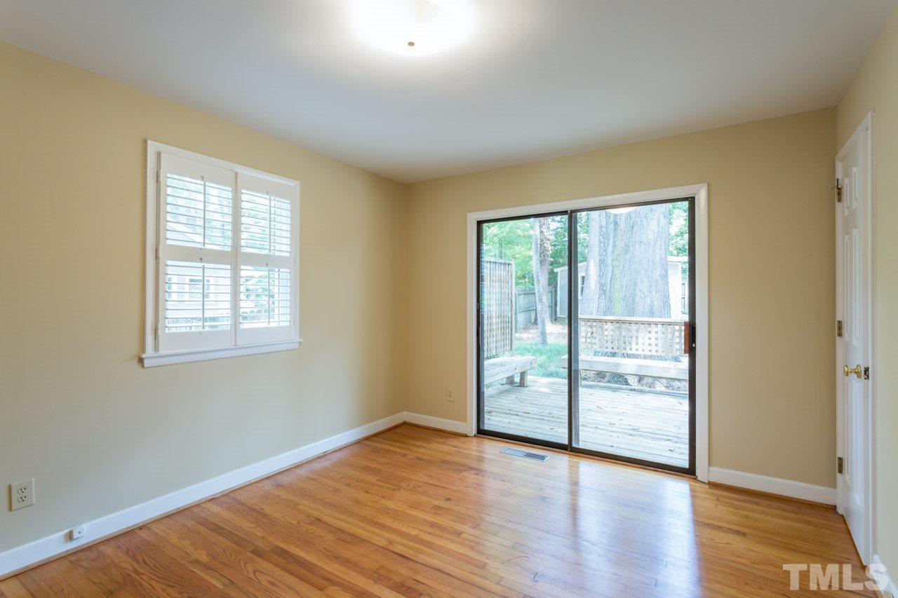 3408 Cherry Lane Raleigh, NC 27607 - Photo 10 of 25 an empty room with wooden floor and windows