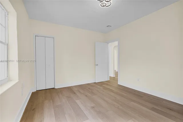 an empty room with wooden floor