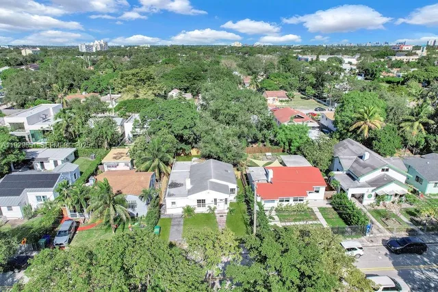 an aerial view of residential houses with outdoor space and street view