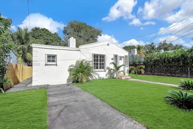 a front view of house with yard and green space