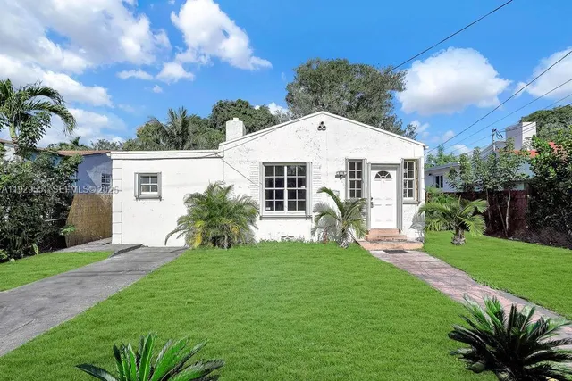 a front view of house with yard and green space