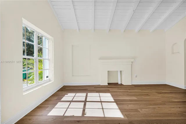 wooden floor in an empty room with a window