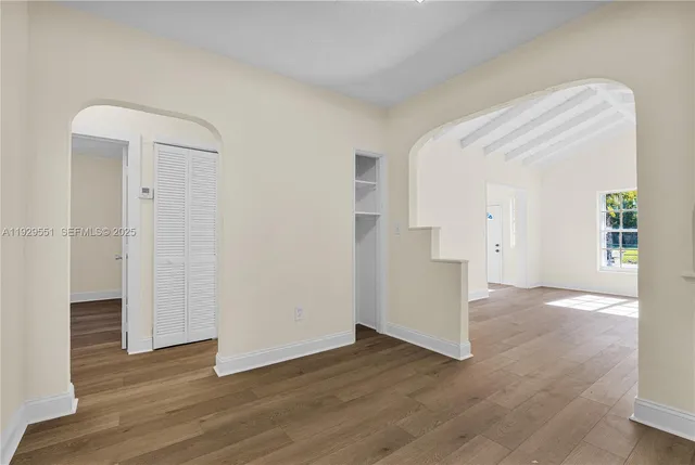 a view of empty room with wooden floor