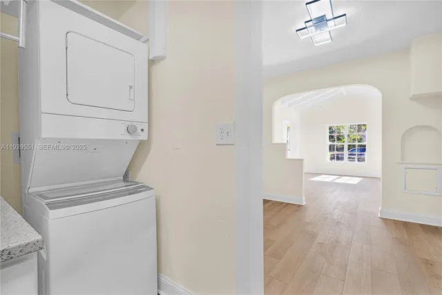 a view of kitchen and hallway with wooden floor
