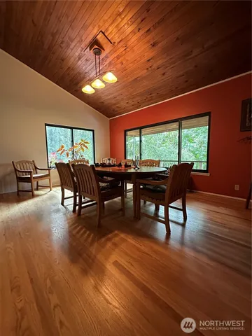 a dining room with furniture a rug and wooden floor