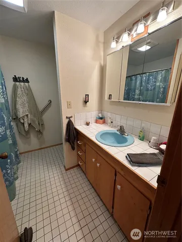a bathroom with a sink and a mirror