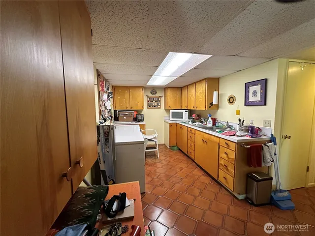 a kitchen with stainless steel appliances a sink and cabinets