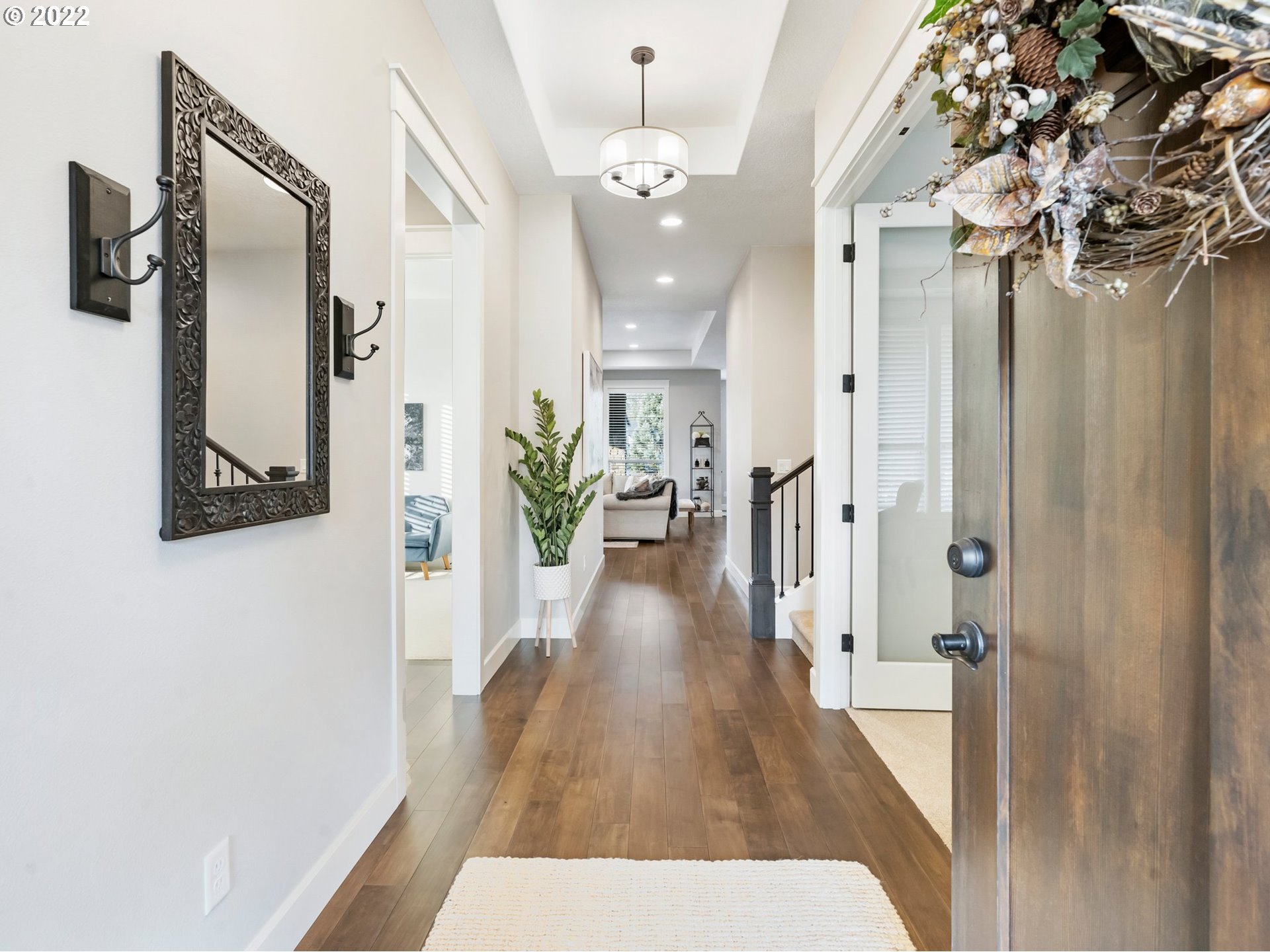2302 Northeast 171st Street Ridgefield, WA 98642 - Photo 8 of 32 view of a hallway with wooden floor and staircase