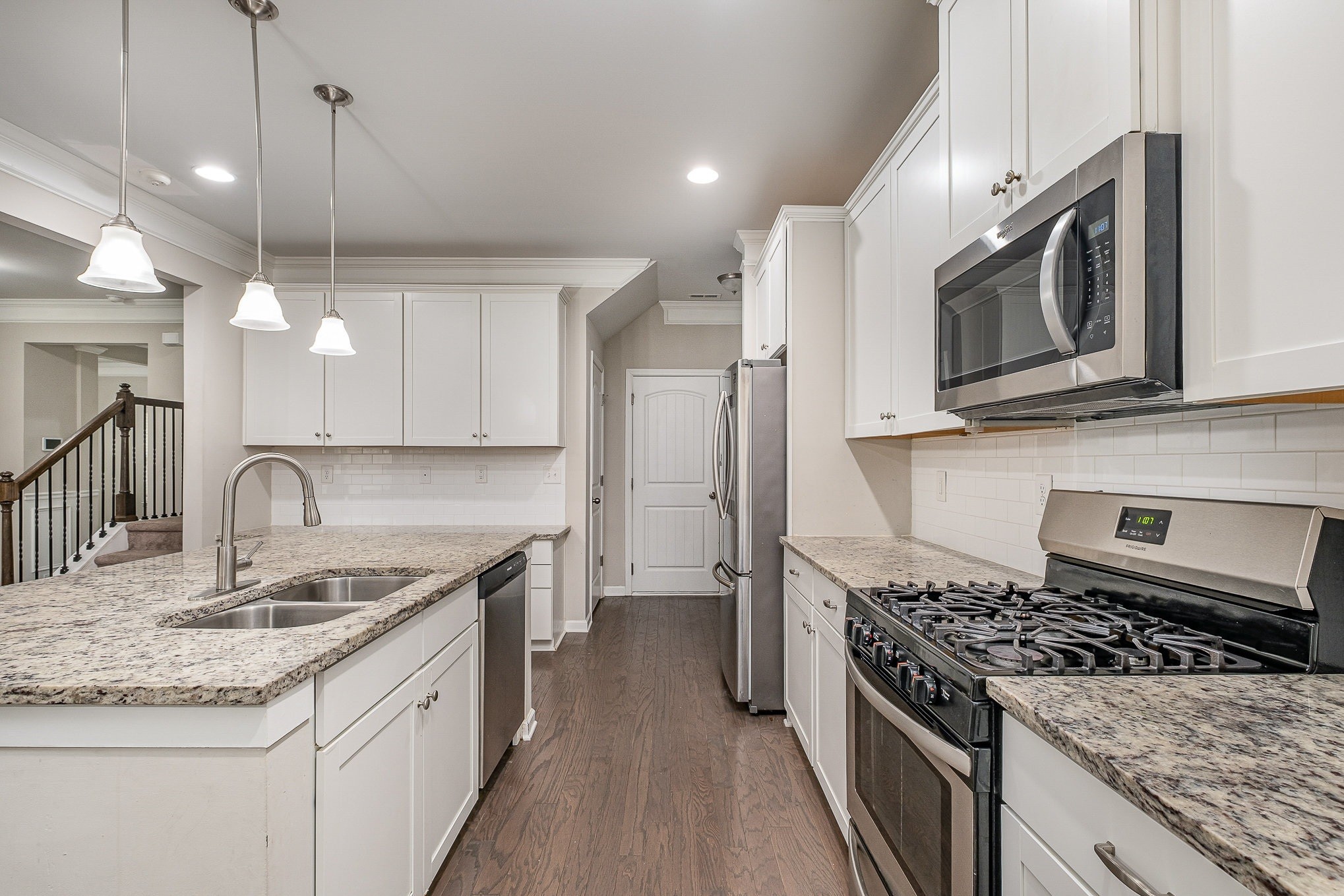 966 Carnation Drive Spring Hill, TN 37174 - Photo 14 of 17 a kitchen with stainless steel appliances granite countertop a sink a stove and a wooden floors