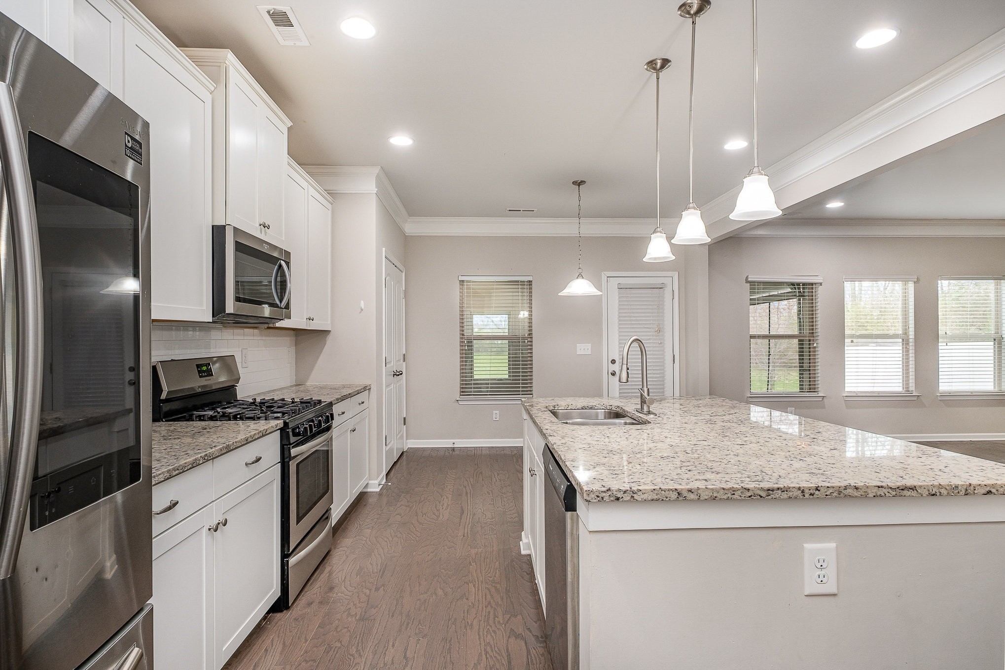 966 Carnation Drive Spring Hill, TN 37174 - Photo 15 of 17 a large kitchen with granite countertop a stove and a sink
