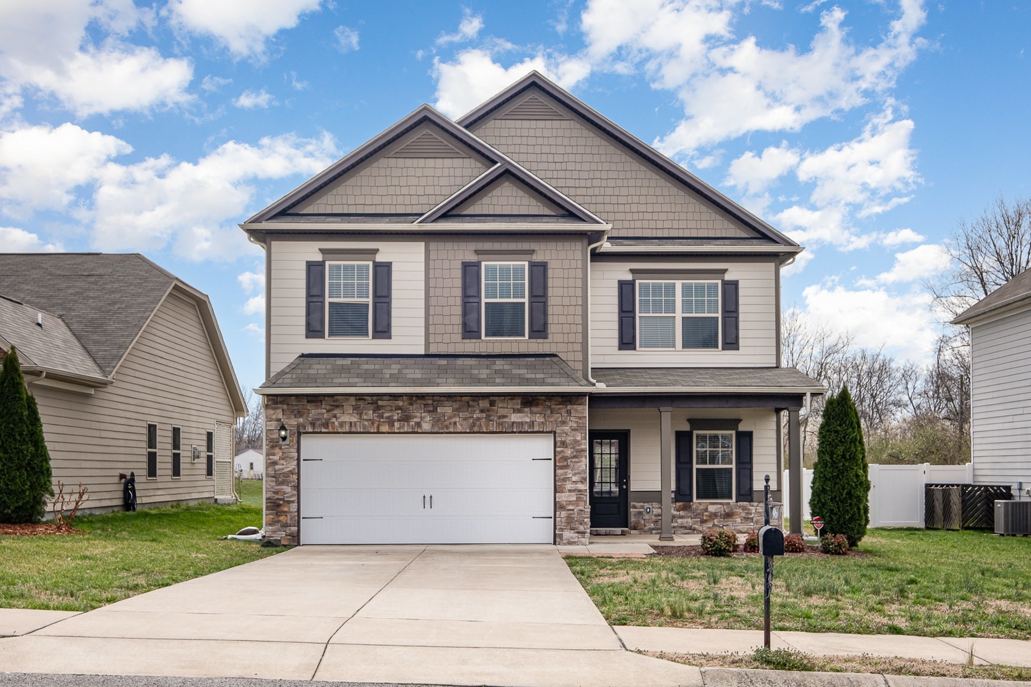 966 Carnation Drive Spring Hill, TN 37174 - Photo 2 of 17 a front view of a house with garden