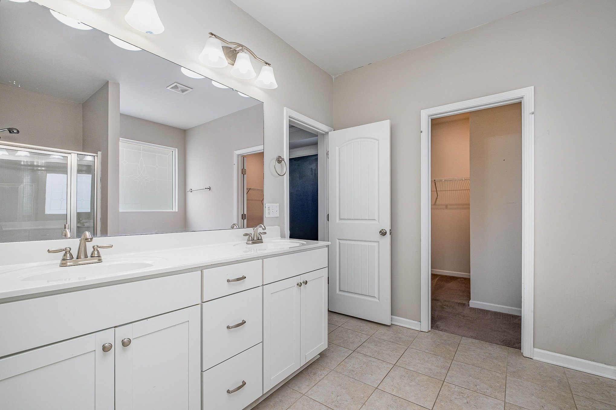966 Carnation Drive Spring Hill, TN 37174 - Photo 7 of 17 a bathroom with a double vanity sink mirror and a