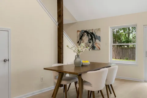 a view of a dining room with furniture and window