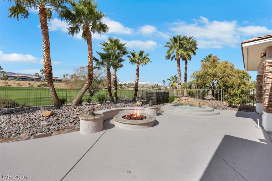 5015 Rivedro Street Las Vegas, NV 89135 - Photo 57 of 91 An inviting fire pit and a rejuvenating spa highlight this expansive patio overlooking a golf course.
