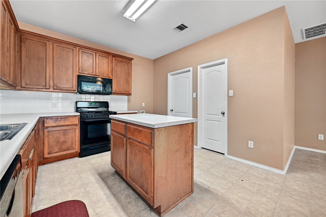 2049 Rachel Lane Round Rock, TX 78664 - Photo 12 of 36 a kitchen with stainless steel appliances granite countertop a refrigerator stove and sink