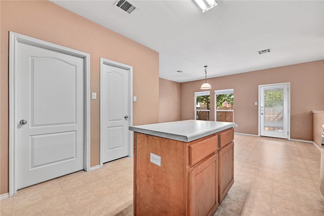 2049 Rachel Lane Round Rock, TX 78664 - Photo 14 of 36 an empty room with kitchen view and wooden floor