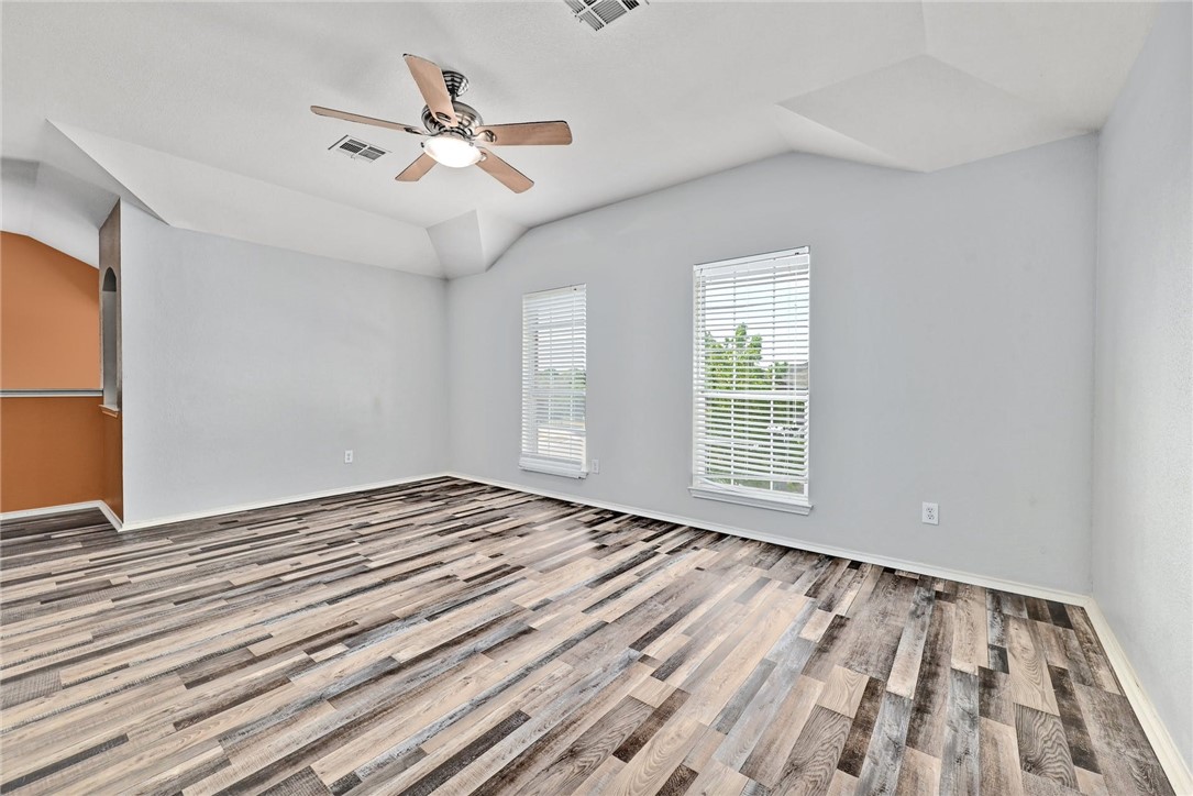 2049 Rachel Lane Round Rock, TX 78664 - Photo 17 of 36 a view of an empty room with wooden floor and a window