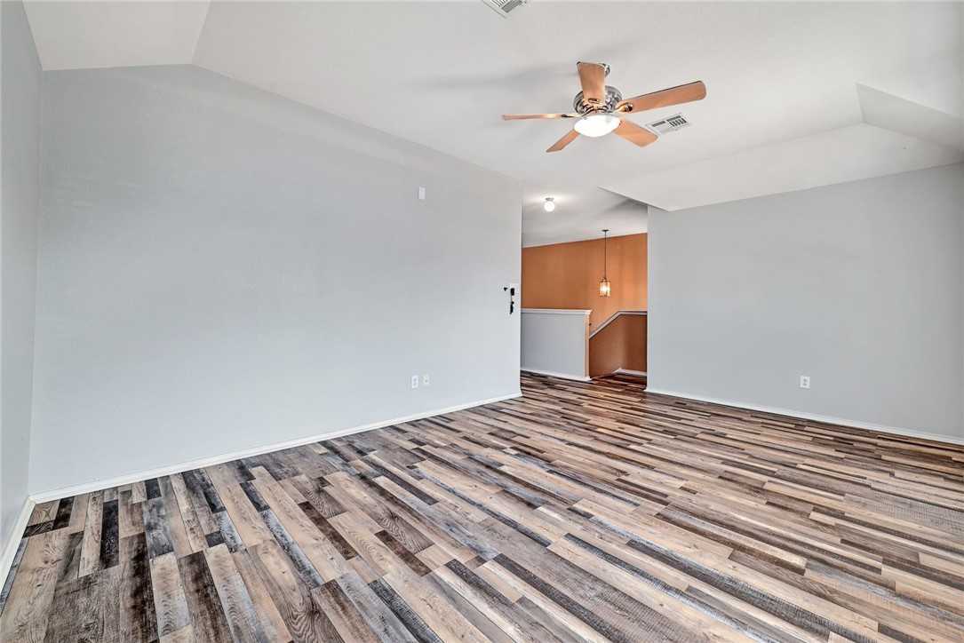2049 Rachel Lane Round Rock, TX 78664 - Photo 18 of 36 a view of a room with a ceiling fan and wooden floor