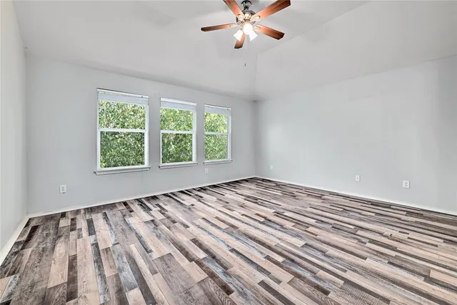 wooden floor in an empty room with a window