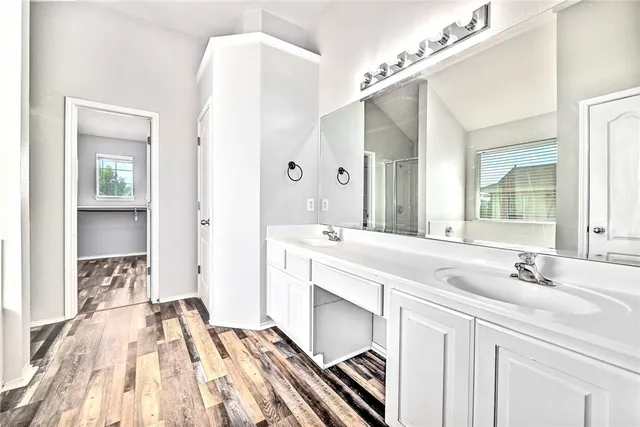 a spacious bathroom with a double vanity sink mirror and