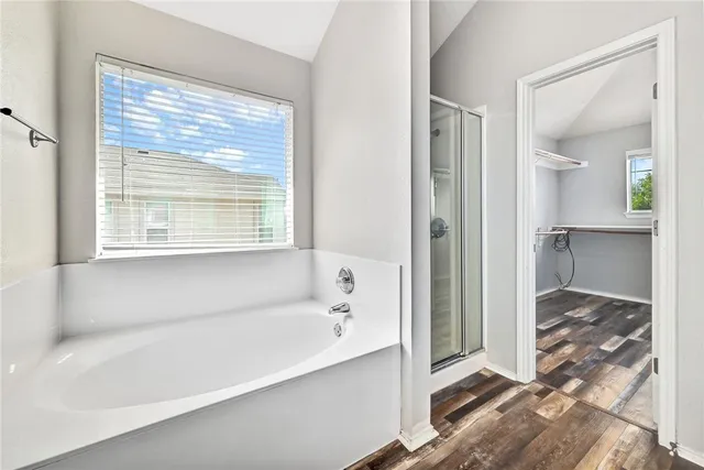 a bathroom with a bathtub and a shower