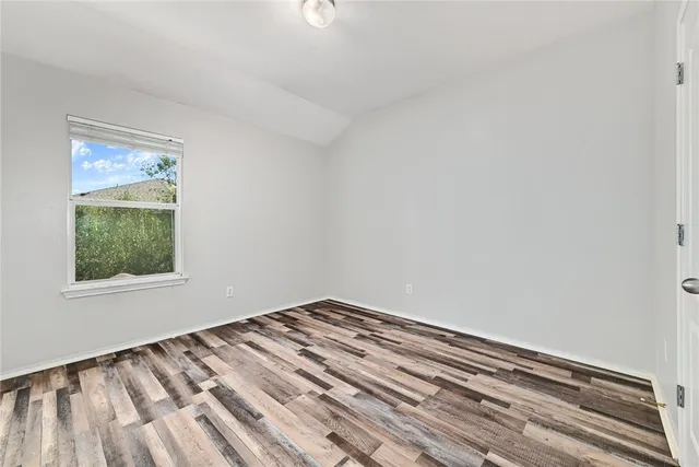 a view of wooden floor and windows in a room
