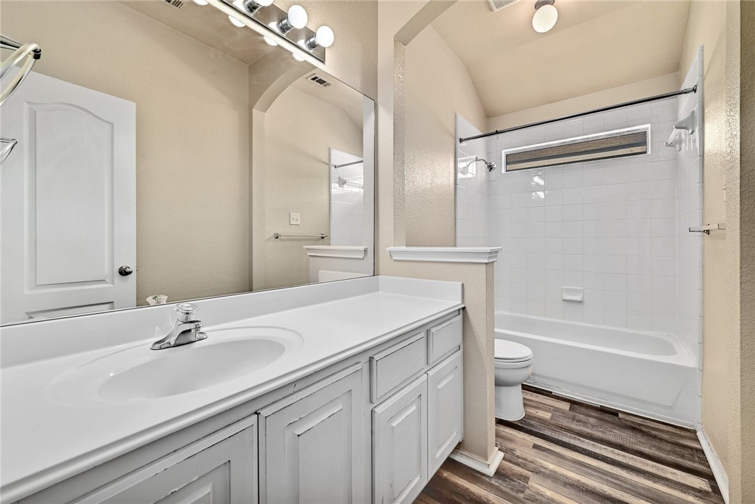 2049 Rachel Lane Round Rock, TX 78664 - Photo 27 of 36 a bathroom with a sink toilet a tub and shower