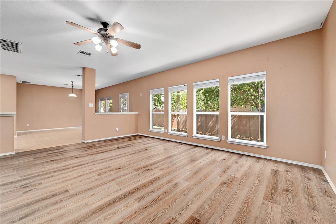 2049 Rachel Lane Round Rock, TX 78664 - Photo 7 of 36 a view of an empty room with a window and wooden floor
