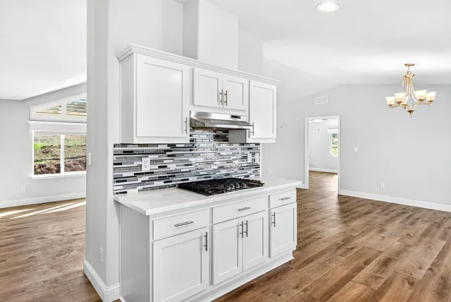 a kitchen with granite countertop a stove and a sink