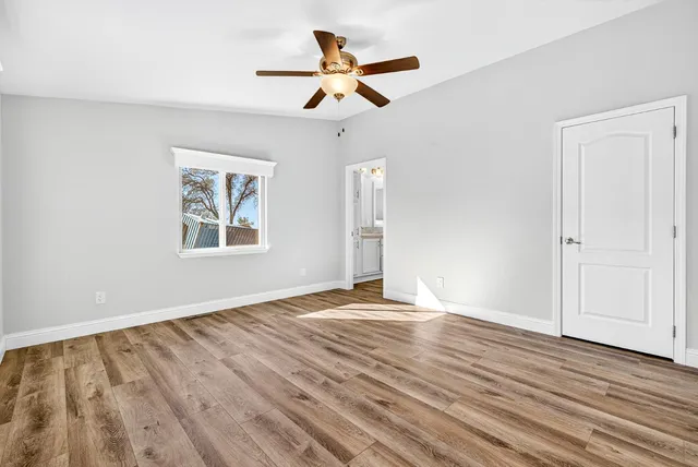 a view of empty room with wooden floor