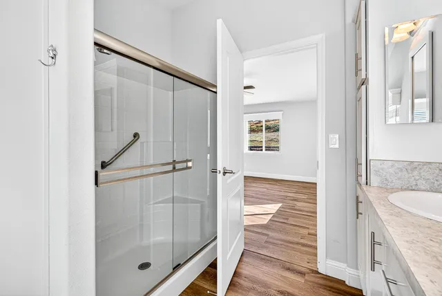 a bathroom with a tub sink and a mirror