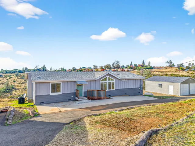 a view of a house with swimming pool and an outdoor seating
