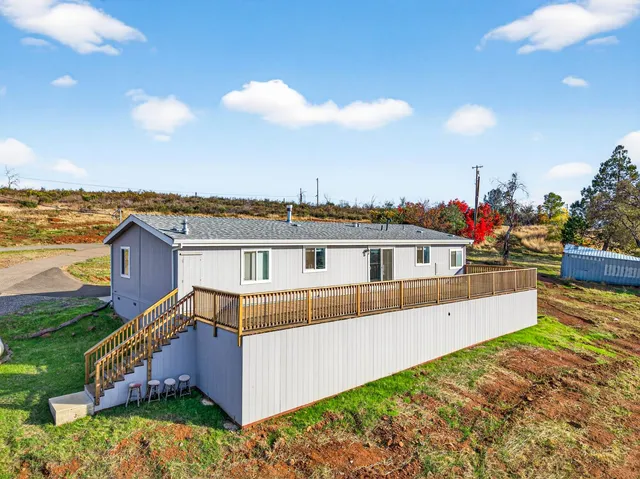 a view of houses with an outdoor space and seating area