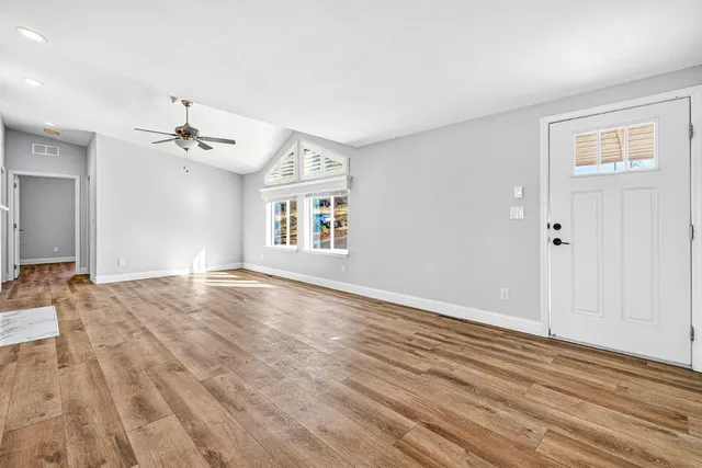 wooden floor in an empty room with a window