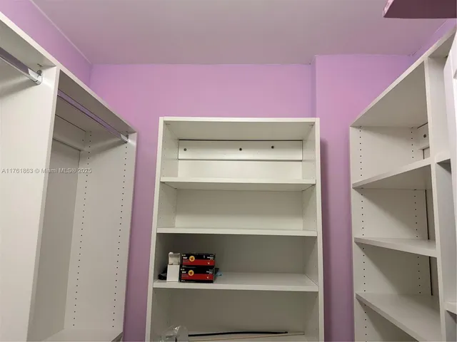 a kitchen with stainless steel appliances kitchen island granite countertop a sink and cabinets