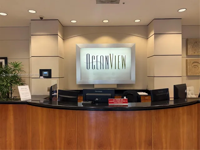 a living room with furniture a white table and a potted plant