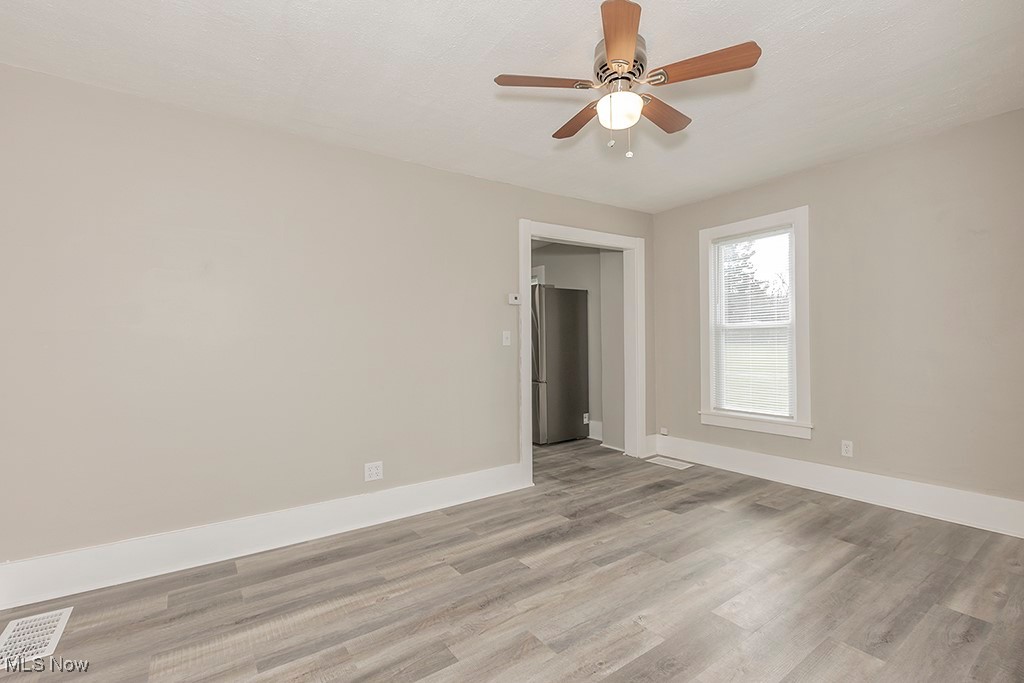 12447 Chillicothe Road Chesterland, OH 44026 - Photo 30 of 42 Unfurnished room featuring light wood-type flooring and ceiling fan