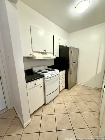 a kitchen with cabinets and appliances