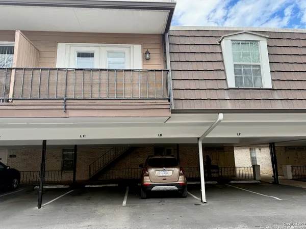 a view of a car park in front of house