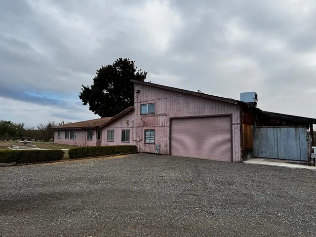 a view of a house with a yard and garage
